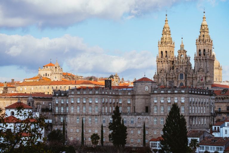 Dramatic view of Santiago de Compostela Cathedral against a blue sky.