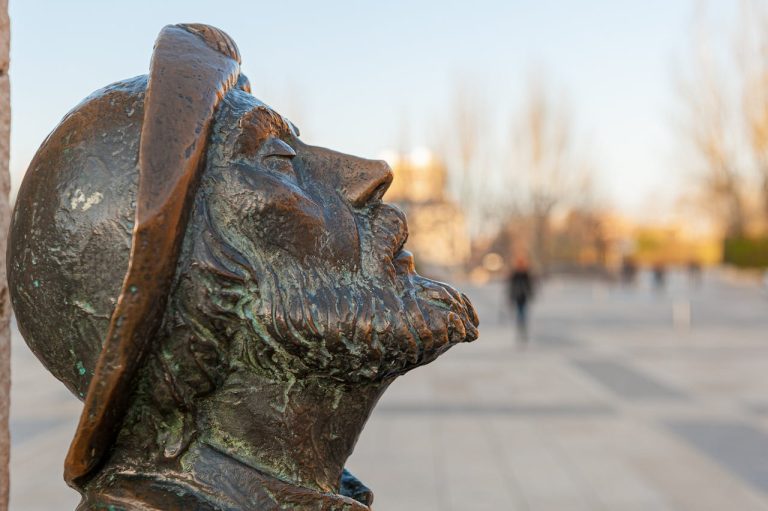 Close-up of a bronze pilgrim statue in Burgos, Spain, showcasing detailed craftsmanship.